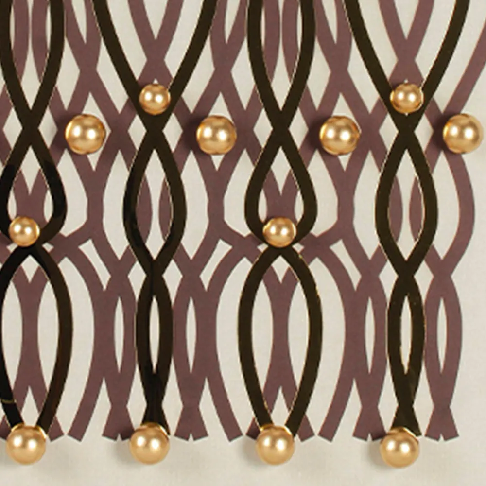 Up close you see the metallic luster of gold spheres and the sharp edges of black hollow lines. The maroon background pattern peeks through subtly — three layers stacked create rich visual depth. That's the magic of 3D wall art.